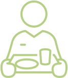 Green outline icon of a person sitting at a table with a plate and cup, symbolizing assisted living services.
